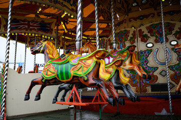 Fototapeta na wymiar Daytime British colorful carnival fair amusement park rides