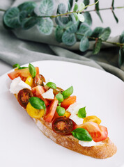 Traditional italian bruschetta with cherry tomatoes and basil leaves