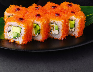 Close up Uramaki California on black plate