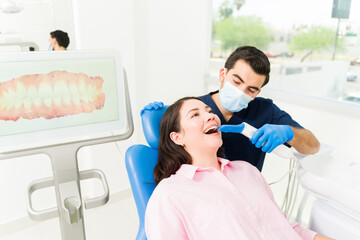 Male dentist making a 3d model of a woman patient