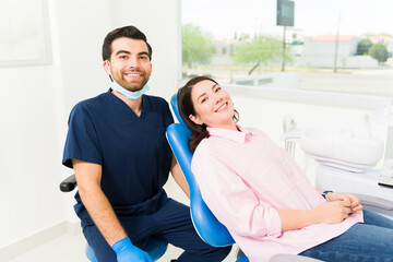 Attractive dentist and beautiful woman patient making eye contact