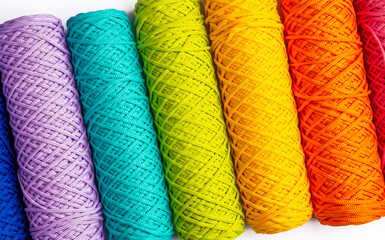 Multi-colored skeins of polyester cords. View from above