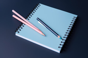 Top view pastel notebook with pencil and stationery on navy blue table background