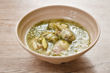 boiled chicken bone with herb and tamarind leaf Thai spicy soup on bowl