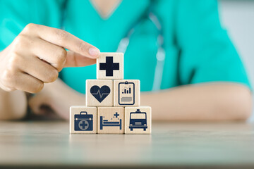 doctor doing a row wood cube block with healthcare medical to plan buy insurance wellnes life comprehensive hospital drug pharmacy ambulance including family money investment retirement - obrazy, fototapety, plakaty
