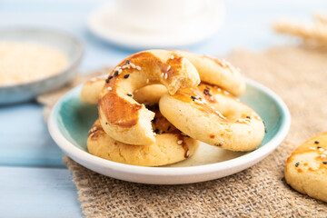 Homemade asian salted cookies, cup of green tea on blue wooden, side view, selective focus.