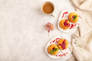 Semolina cheesecake with strawberry jam on gray concrete, top view, copy space.