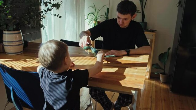 Father and son play with toys. Parents and children.