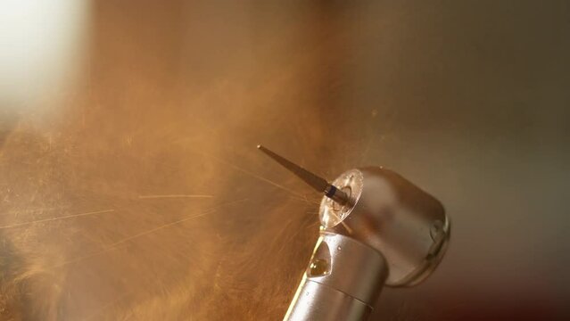 Dental care concept. Working dental drill machine with water. Close-up of dental tool. Dental procedures in modern dentist office. 4K, UHD