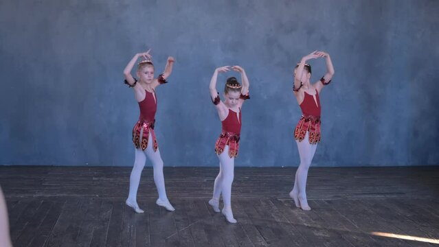Dancing, training and group of ballerina in studio doing performance routine. Exercise, practice and diversity in ballet class, young women doing choreography dance together with grace and elegance