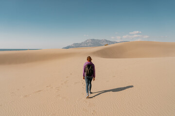 Lonely woman on dunes of Patara Beach Turkey.