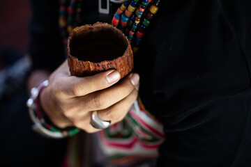  Handmade ceremonial cacao cup. Man hands holding craft cocoa.