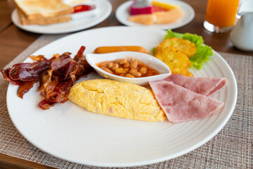 breakfast set - omelette, bacon, ham, sausages, fresh vegetable salad