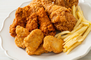 fried chicken with french fries and nuggets on plate