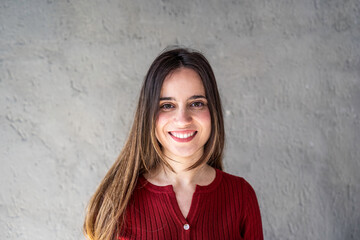 Portrait of happy caucasian woman - Confident and smiling young  woman with long brown smooth hair having fun while posing in front of the camera - Young generations and gen z concept - obrazy, fototapety, plakaty