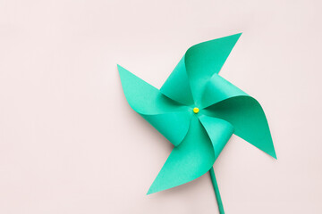 Paper origami green windmill, copy space.