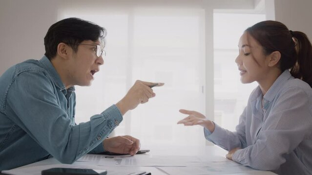 Bad colleagues work argue point face stress rude yelling anger hate speech at female coworker. Two adult asia people man woman fight on meeting at office upset mad bossy male worker. Career job issue.