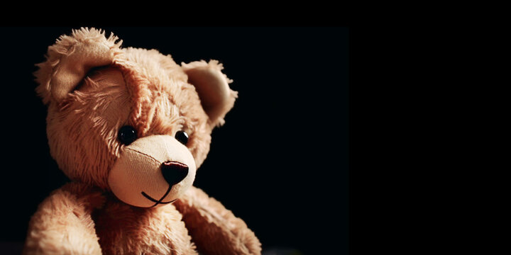 Teddy bear on a black background with copy space for text. Generative AI