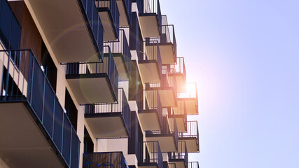 Modern apartment buildings on a sunny day with a blue sky. Facade of a modern apartment building. Contemporary residential building exterior in the daylight. 