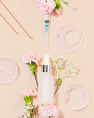 Concept of beauty injections. Syringe with toxin dropper bottle with serum and flowers on pink...