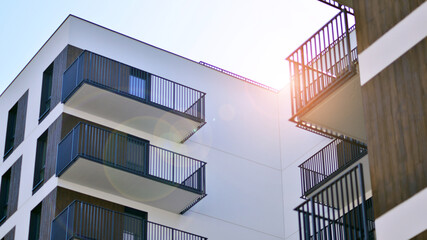 Modern apartment buildings on a sunny day with a blue sky. Facade of a modern apartment building. Contemporary residential building exterior in the daylight. 