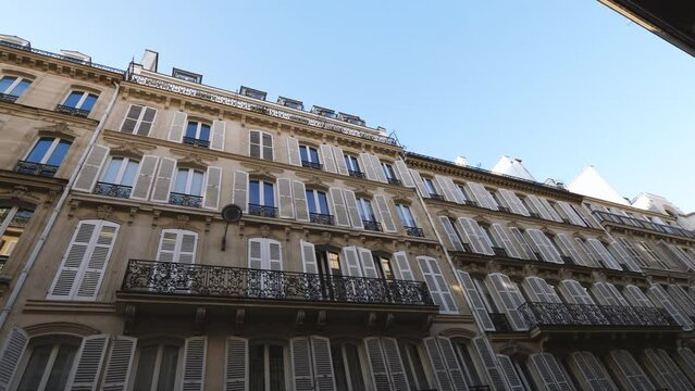 An elegant, traditional French apartment in Paris with an iconic balcony and classic stone facade. A perfect investment or vacation destination or for living