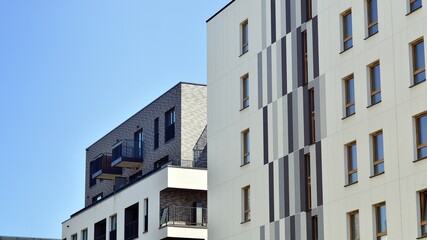 Modern apartment buildings on a sunny day with a blue sky. Facade of a modern apartment building. Contemporary residential building exterior in the daylight. 