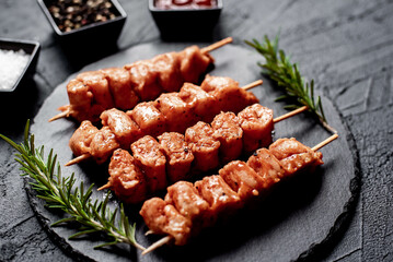 raw turkey skewers
on a stone background