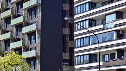 Modern apartment buildings on a sunny day with a blue sky. Facade of a modern apartment building. Contemporary residential building exterior in the daylight. 