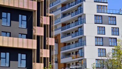 Modern apartment buildings on a sunny day with a blue sky. Facade of a modern apartment building. Contemporary residential building exterior in the daylight. 