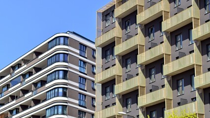 Modern apartment buildings on a sunny day with a blue sky. Facade of a modern apartment building. Contemporary residential building exterior in the daylight. 