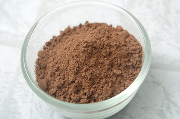 Obraz na płótnie Canvas cocoa powder in a glass bowl, ingredient for baking, make a cake