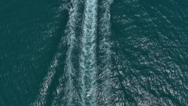 Drone film of large speed boat - Drone comes from behind the boat camera pans up to show the boat in a birds&nbsp;view angle - Thailand 