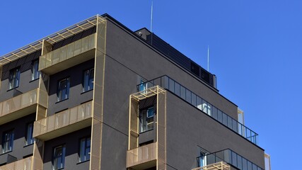Modern apartment buildings on a sunny day with a blue sky. Facade of a modern apartment building. Contemporary residential building exterior in the daylight. 