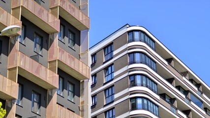 Modern apartment buildings on a sunny day with a blue sky. Facade of a modern apartment building. Contemporary residential building exterior in the daylight. 