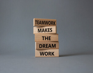 Teamwork symbol. Wooden blocks with words Teamwork makes the Dream work. Beautiful grey background. Business and Teamwork makes the Dream work concept. Copy space.