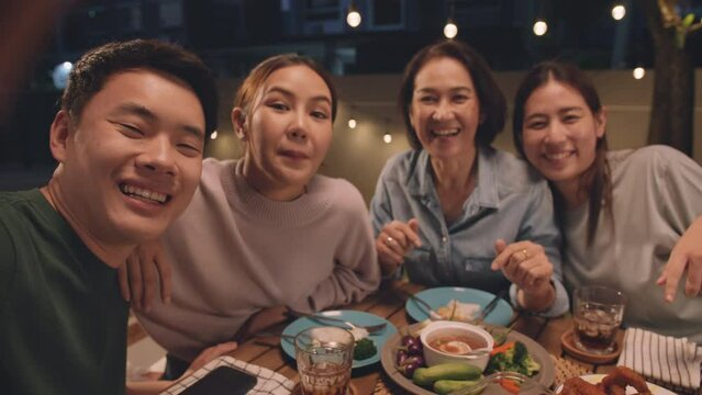 POV webcam screen group facetime videocall look at camera greeting smile laugh fun joy talk online at dine table night party at home. Enjoy mobile phone selfie app with young senior middle aged mom.