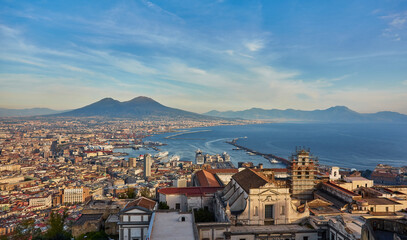 Fototapeta premium Naples, Italy: Panoramic view of the city and port with Mount Vesuvius on the horizon as seen from the hills of Posilipo.