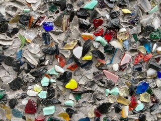 small colorful glass shards on a gray surface