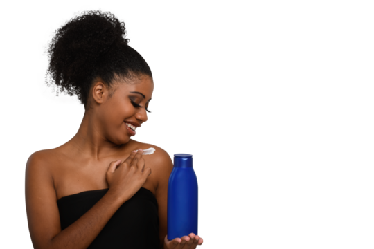 a woman applying moisturizing cream to her skin, smiling while holding a bottle demonstrating skin care