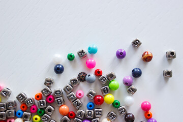 Background from different colored beads with numbers and symbols, top view