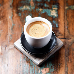 Cup of coffee on wooden background. Close up.	