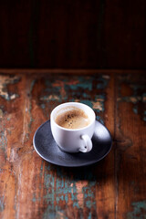 Cup of coffee on wooden background. Close up.	