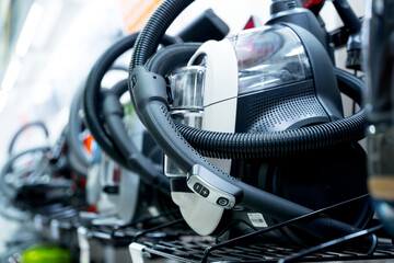 Row of variety vacuum cleaners at the showroom of a large store 