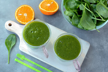 Fresh spinach, banana and orange fruit smoothie. Detox green drink