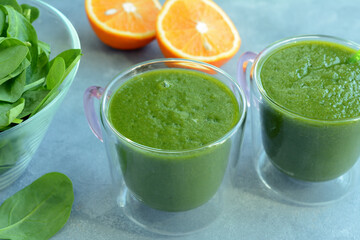 Fresh spinach, banana and orange fruit smoothie. Detox green drink