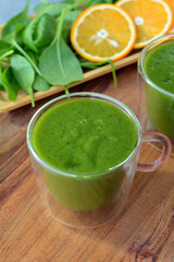 Fresh spinach, banana and orange fruit smoothie. Detox green drink