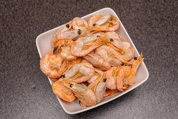 A lot of big shrimps, prawns in the plate on the table