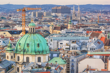 Fototapeta na wymiar City landscape - top view on The Peterskirche (St. Peter's Church) and the roofs of the old city of Vienna, Austria