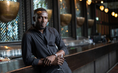 Portrait of confident African American businessman at nightclub.